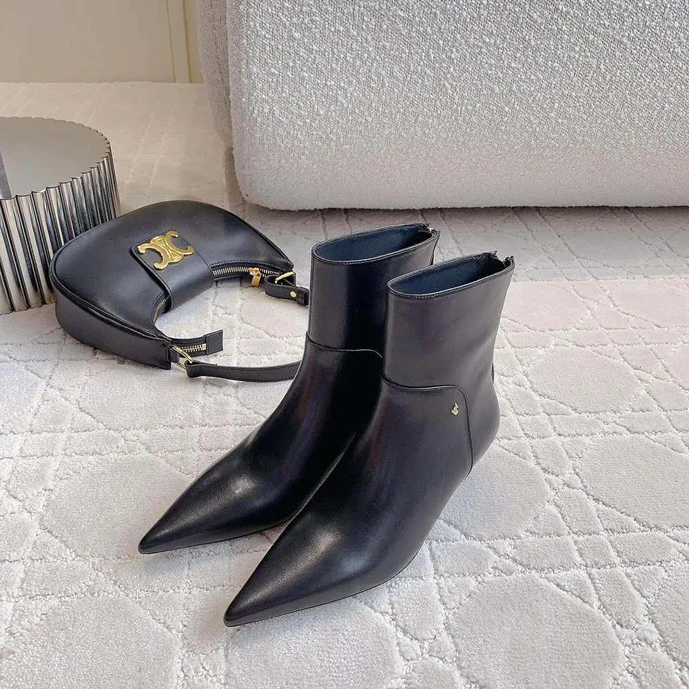 Front angle showing sculpted 50mm heel of Jimmy Choo Women Cycas Ankle Boot 50