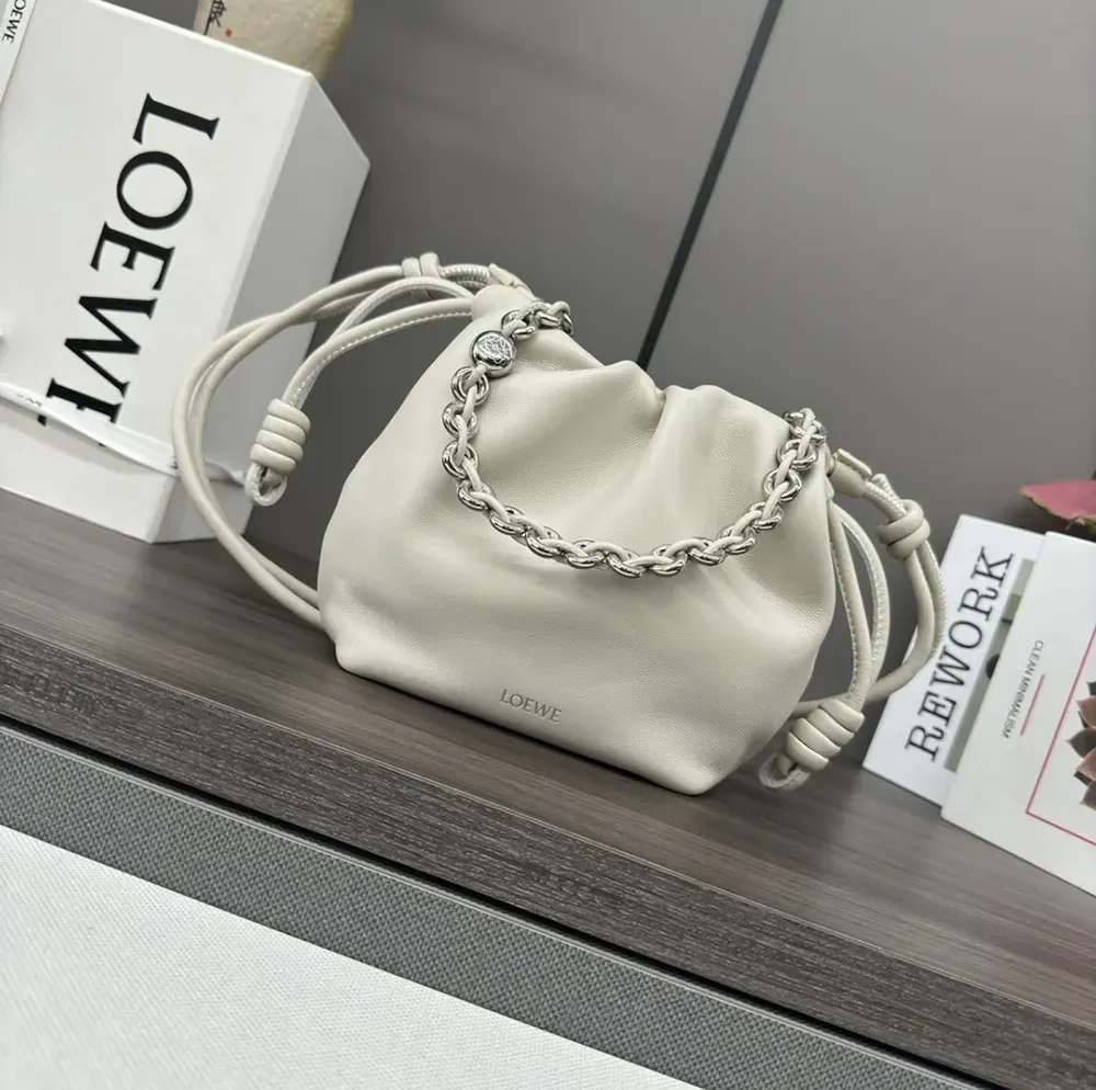 Close-up of ruffled flap and silver hardware on Loewe Mini Flamenco purse