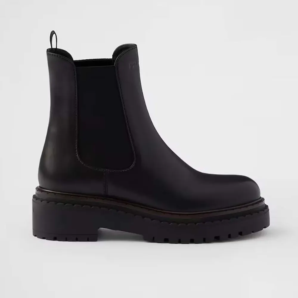Side view of Prada Men Leather Chelsea Boots-Black showing elastic panel