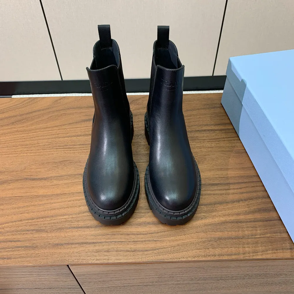 Close-up of black calfskin leather texture on Prada Chelsea boots