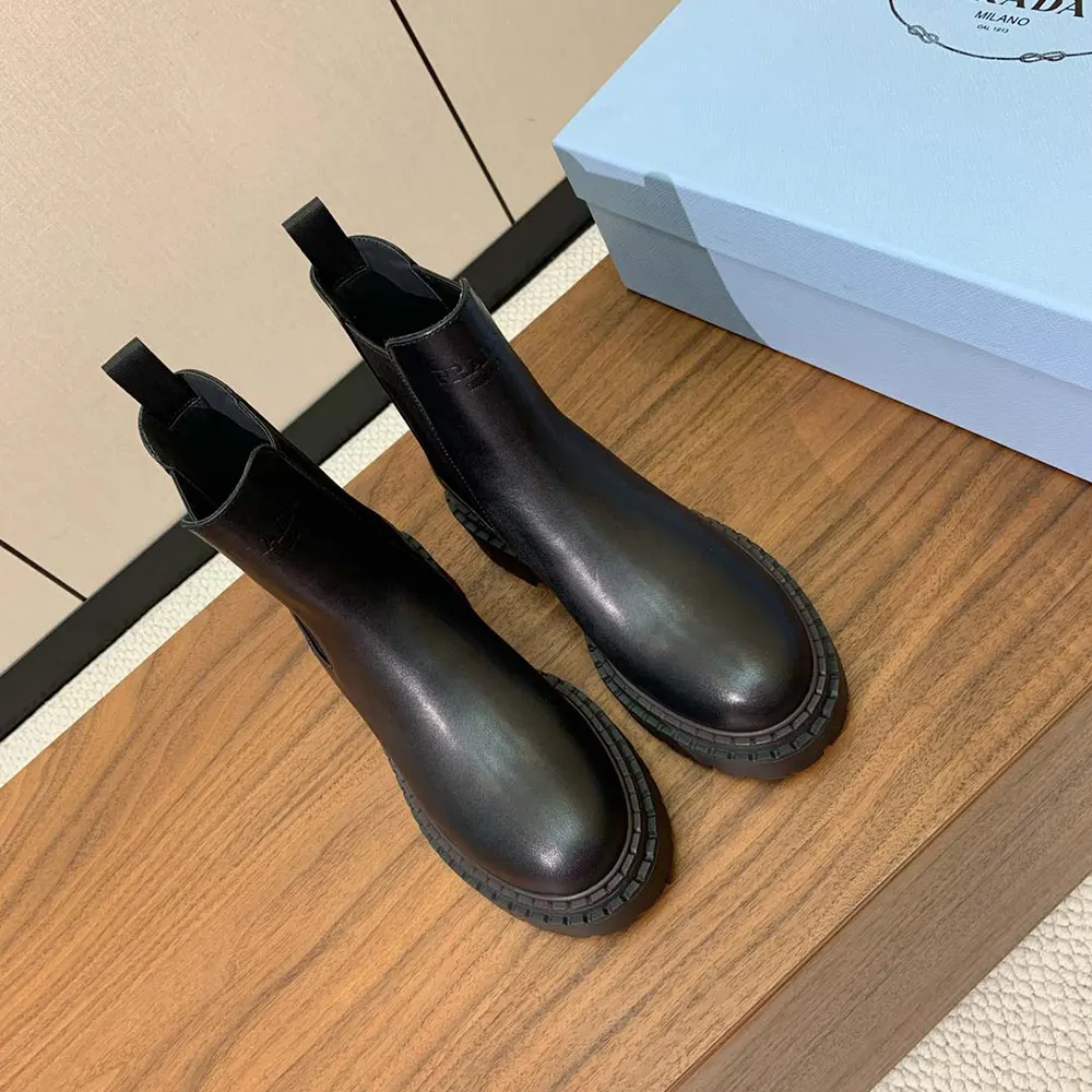 Rear angle highlighting heel and stitched sole of Prada Men Leather Chelsea Boots-Black