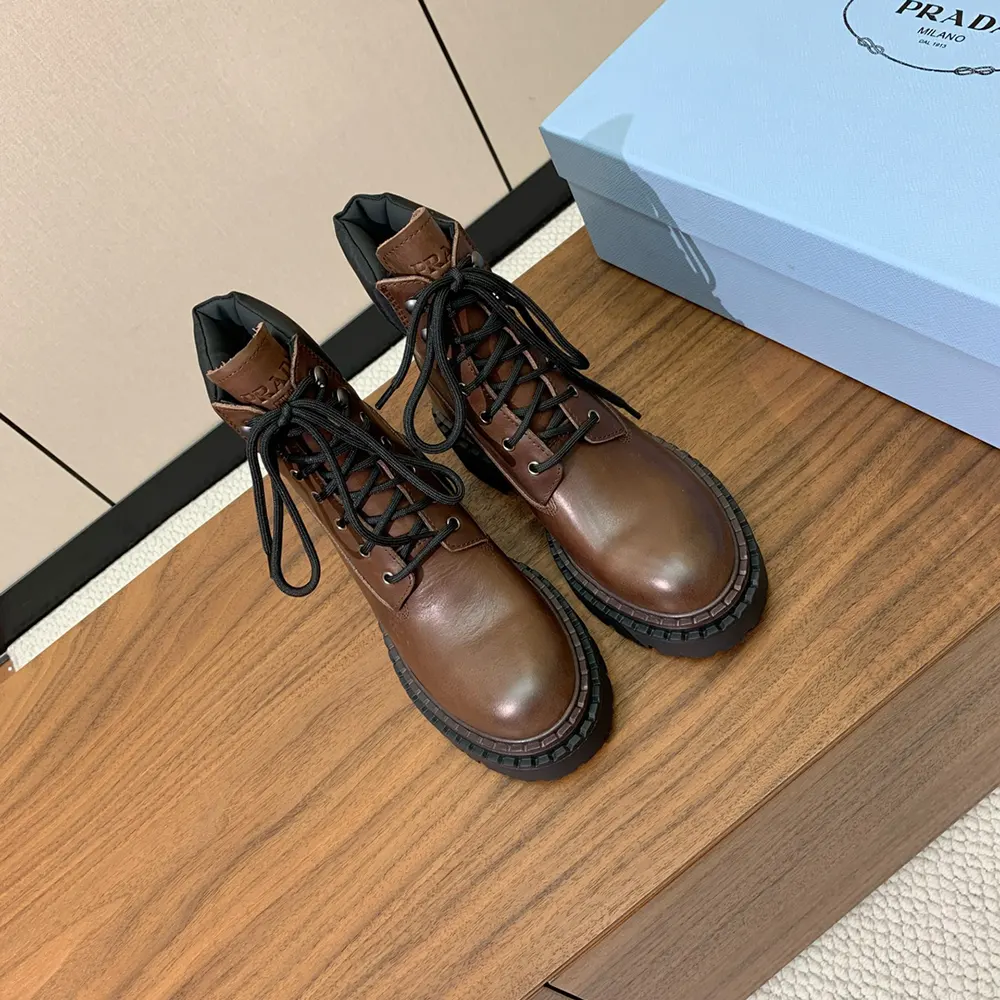 Top-down angle highlighting leather texture on Prada Unisex booties-Cognac