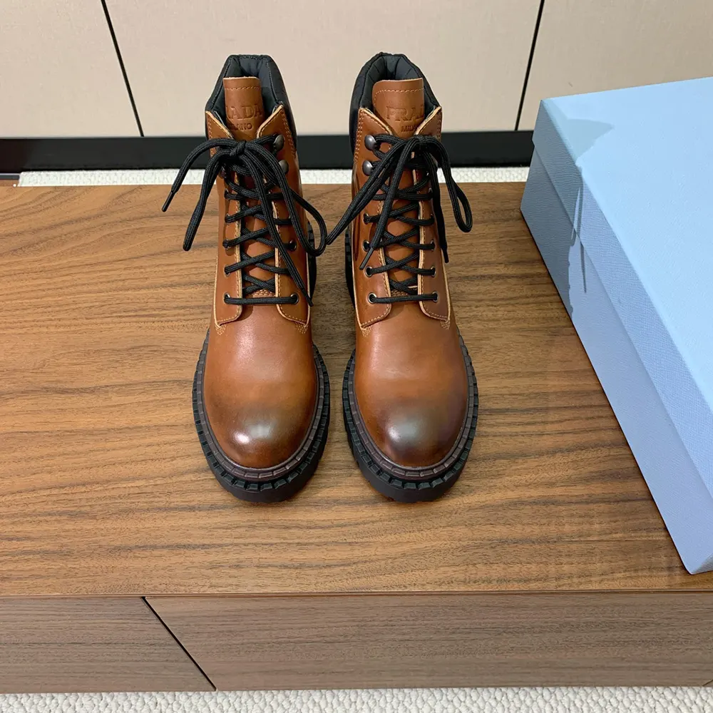Side profile highlighting brown leather and Re-Nylon mix on Prada booties