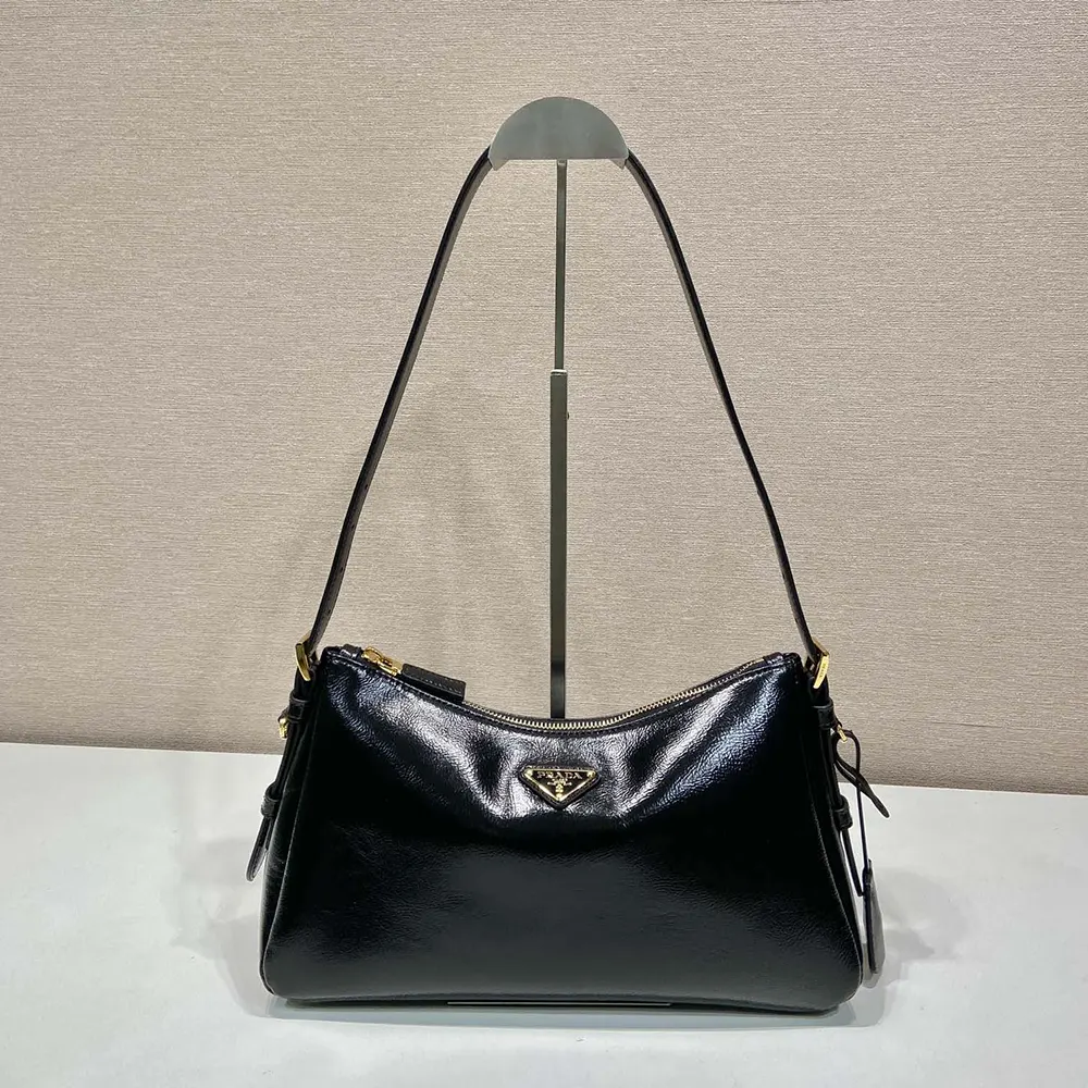 Close-up of silver-tone Prada logo closure on Aimée shoulder bag