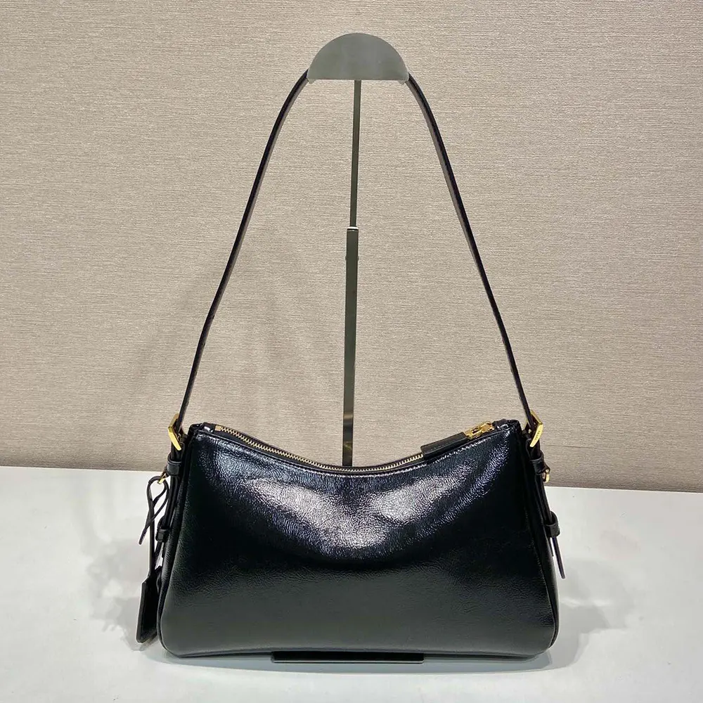Side angle showing structured silhouette of Prada Aimée Medium Naplak Leather Shoulder Bag