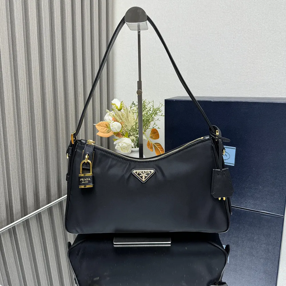 Close-up of gold padlock hardware on Prada Women Aimée shoulder bag