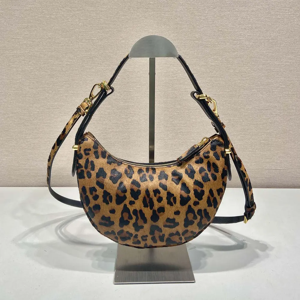 Side profile showing adjustable strap on Prada Women Arqué Printed Leather Shoulder Bag