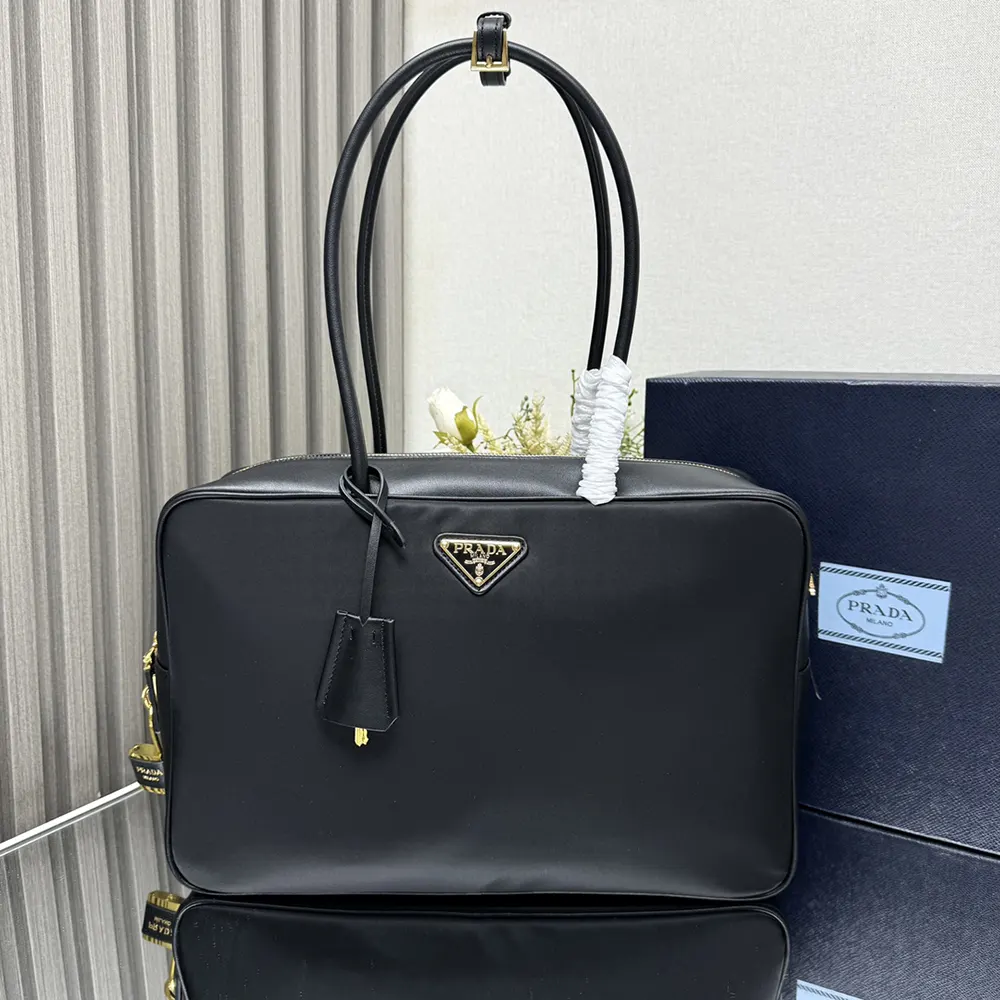 Close-up of padlock detail on Prada Women Large Re-Nylon and Leather Top-handle Bag
