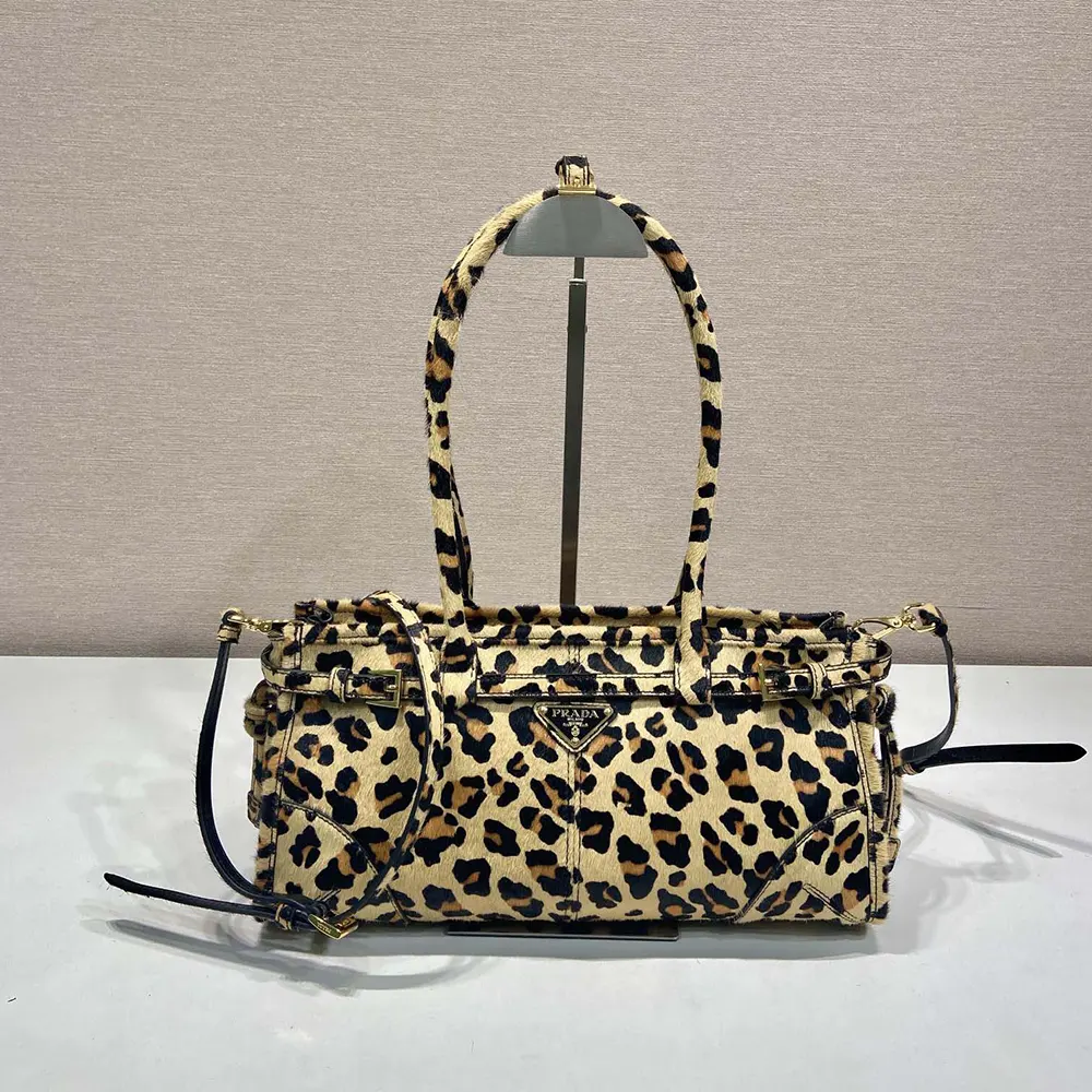 Close-up of gold-tone hardware and embossed logo on Prada handbag