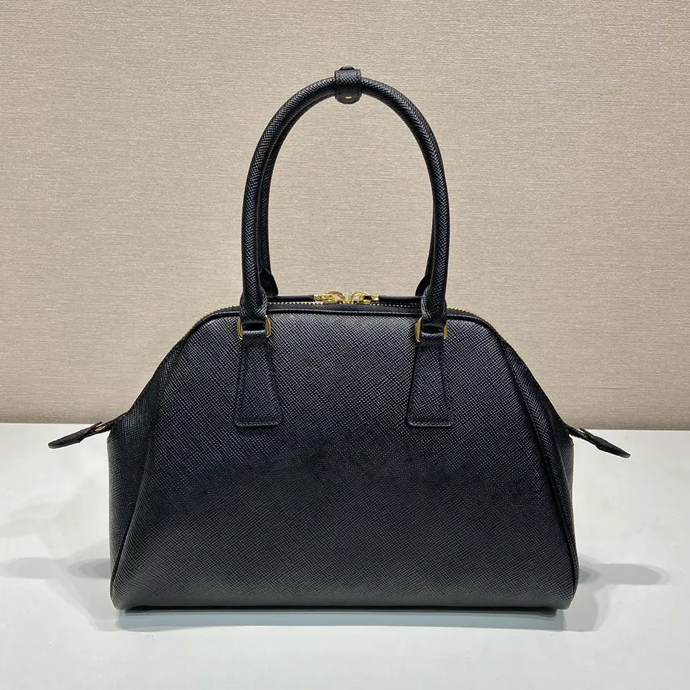 Side angle showing the adjustable strap and silhouette of Prada Medium Saffiano Leather Bag-Black