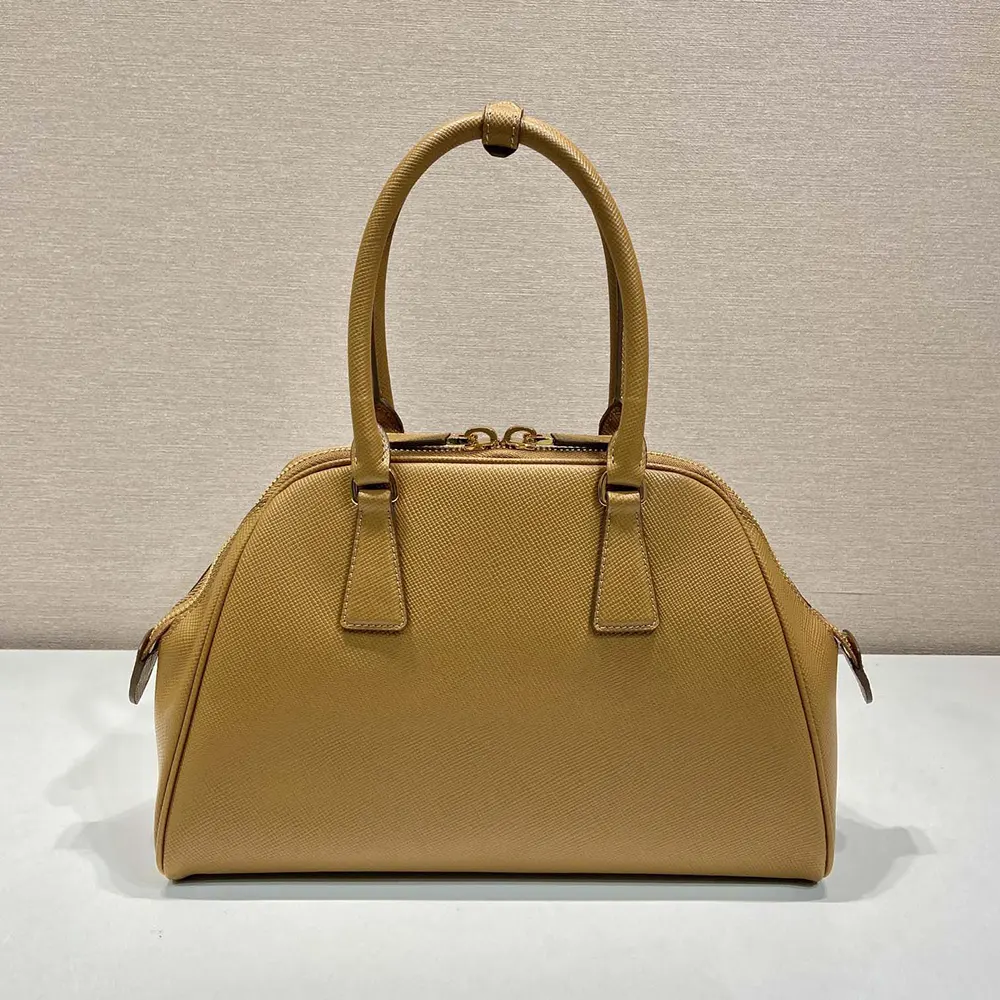 Side angle showing strap and silhouette of Prada Women Medium Saffiano Leather Bag