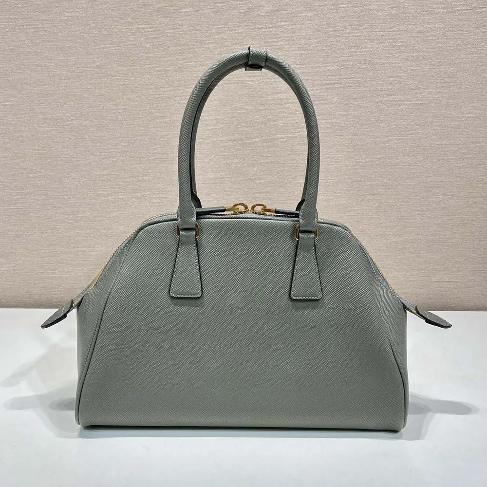 Side angle showing adjustable strap and zip closure of Prada Women Medium Saffiano Leather Bag-Gray