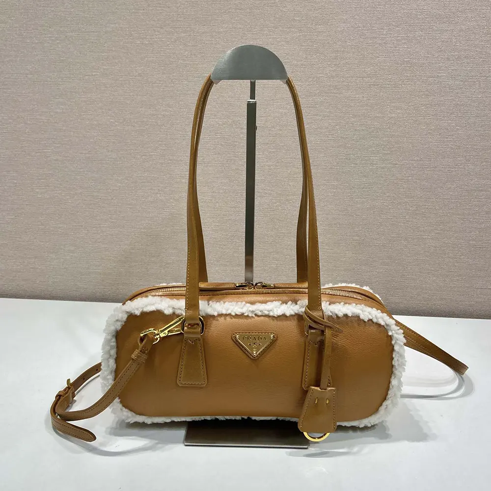 Close-up of shearling texture and gold hardware on Prada bag