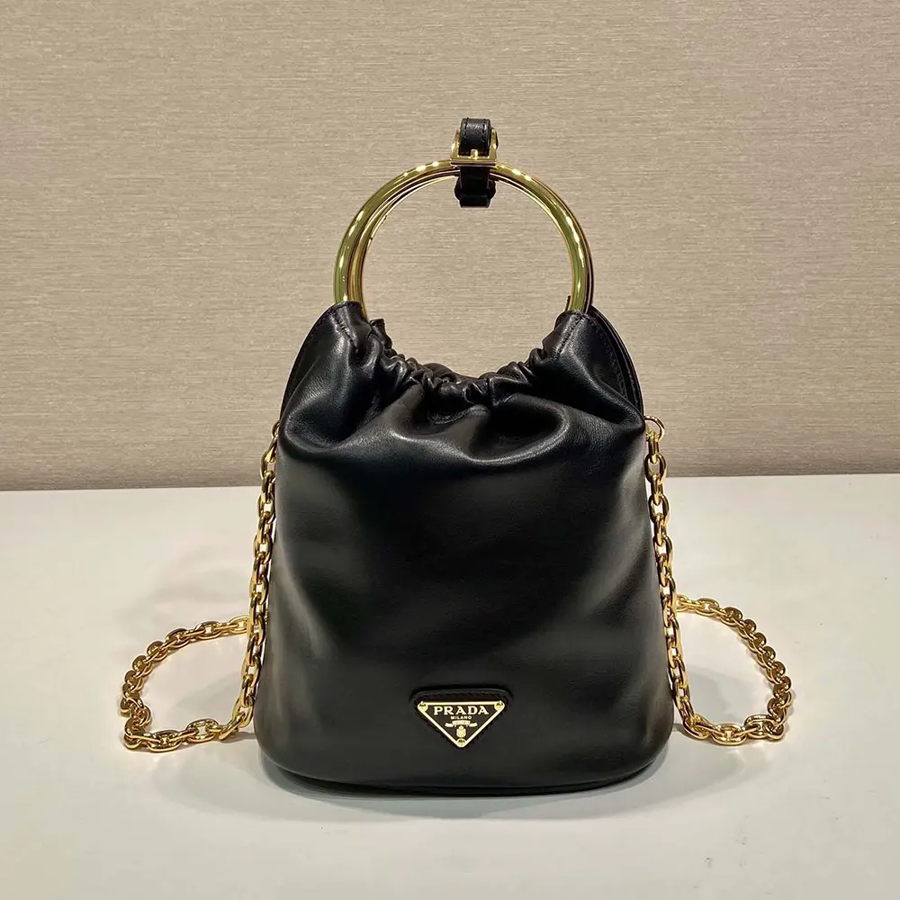 Close-up of silver-tone Prada logo hardware on mini bag