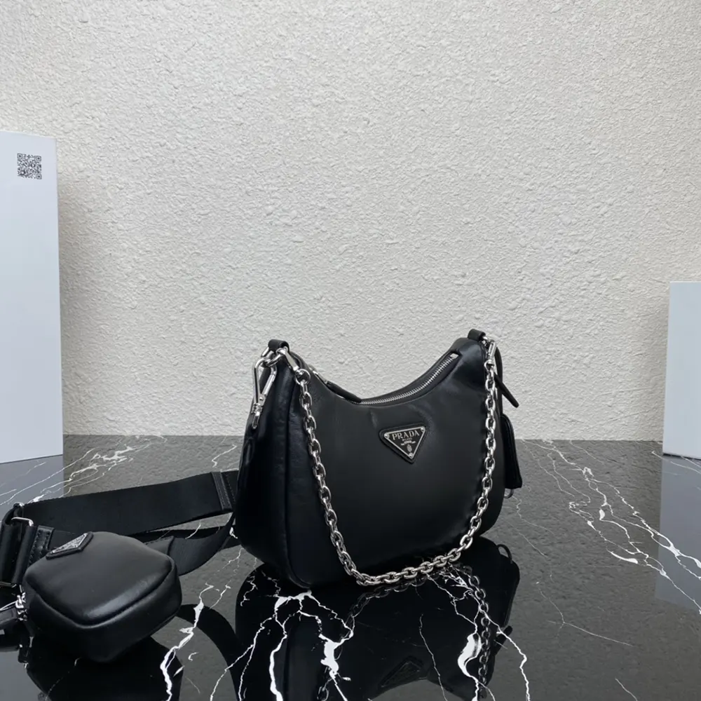 Side angle showing compact silhouette and magnetic snap closure on Prada bag