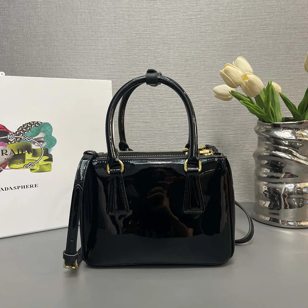 Side angle showing glossy patent leather texture on Prada Mini Bag
