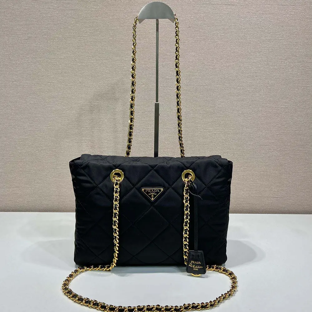 Close-up of silver-tone chain handle on Prada Re-Edition 1995 tote bag