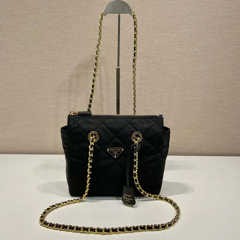 Close-up of silver chain handle on Prada Women Re-Edition 1995 Chaîne Re-Nylon Tote Bag-Black