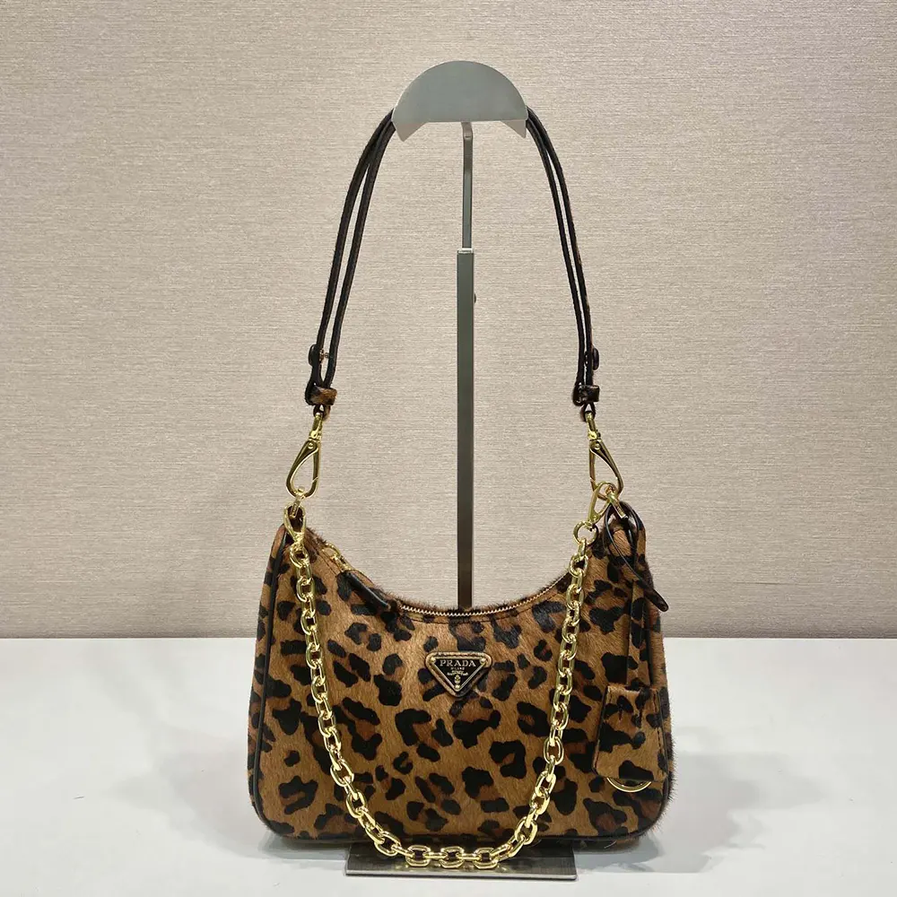 Close-up of gold-tone logo hardware on Prada Women Re-Edition Mini-bag