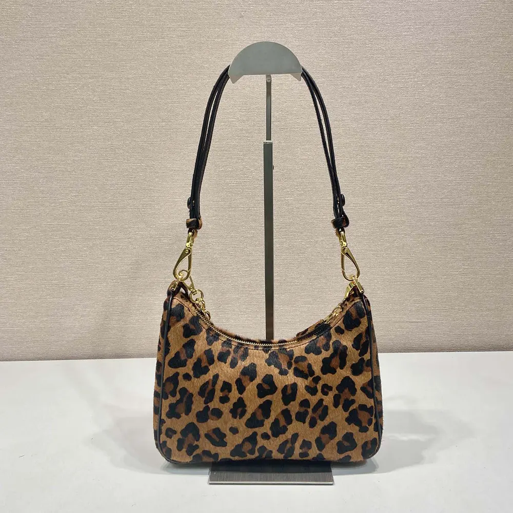 Side angle showing adjustable strap on Prada Women Re-Edition Mini-bag