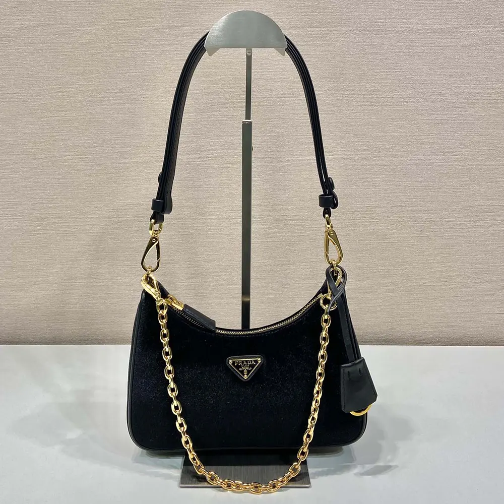 Close-up of plush velvet texture and Prada logo on mini-bag