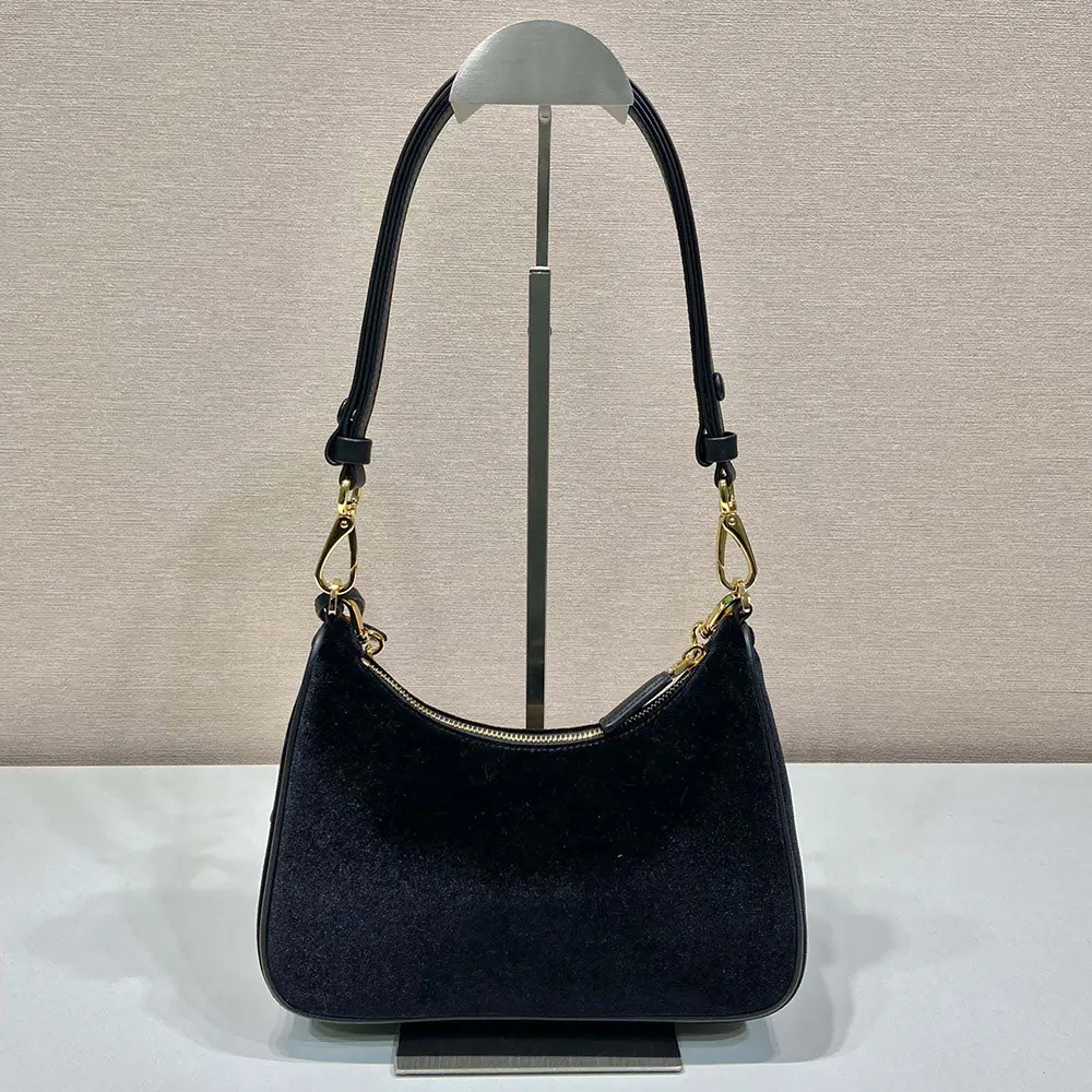 Side angle showing compact silhouette and adjustable strap of Prada mini-bag