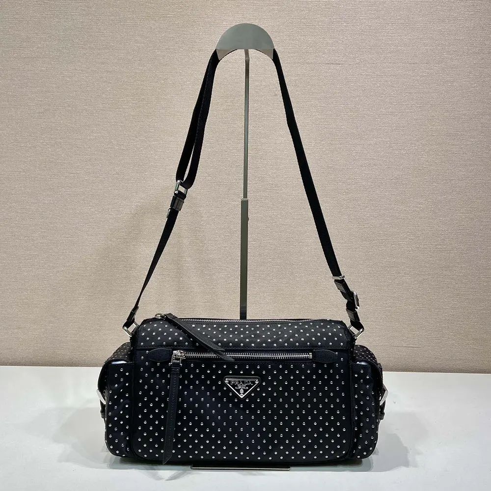 Close-up on silver studs and zipper of Prada Women Re-Nylon Bag with Studs