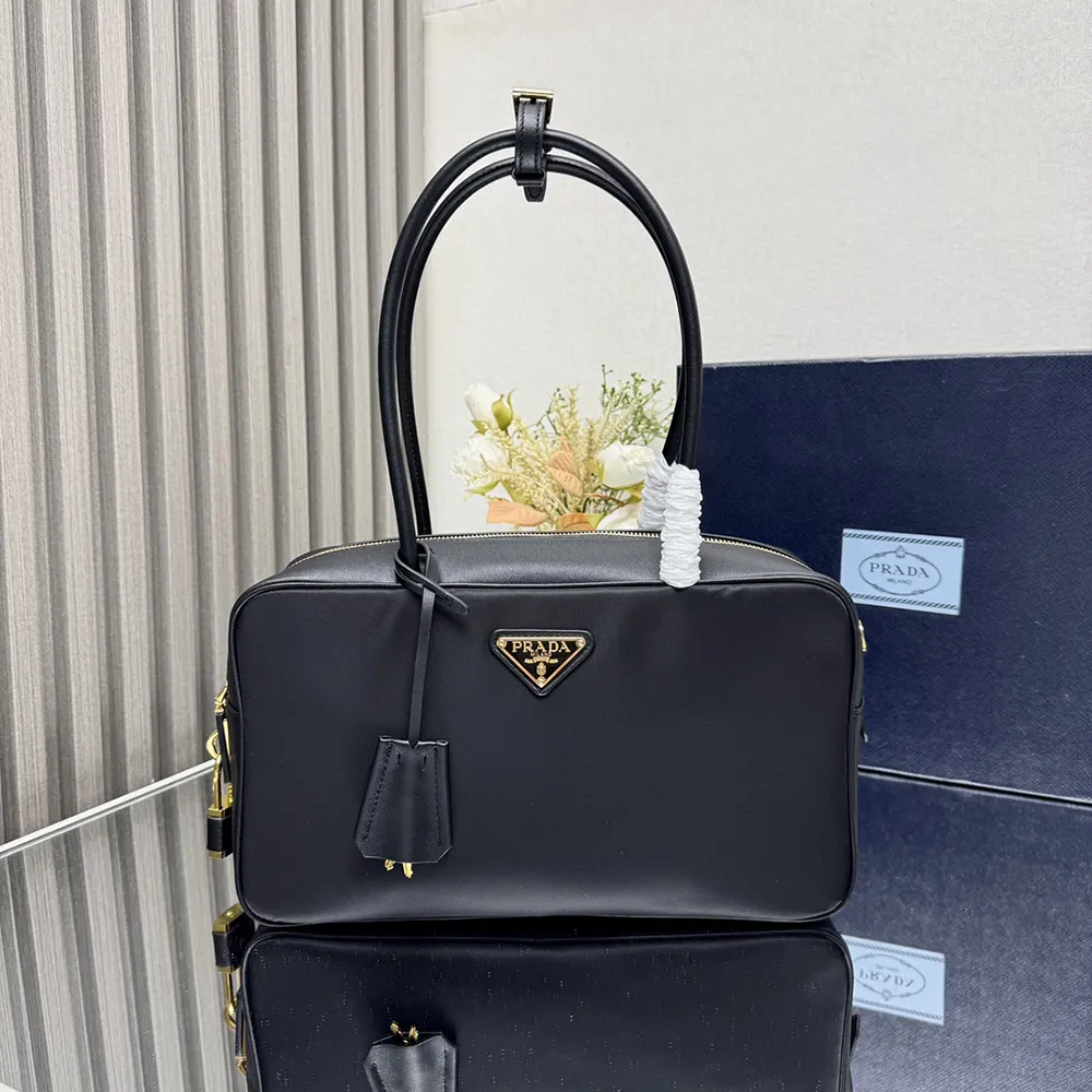 Close-up detail of padlock and leather on Prada Women Re-Nylon Medium Bag
