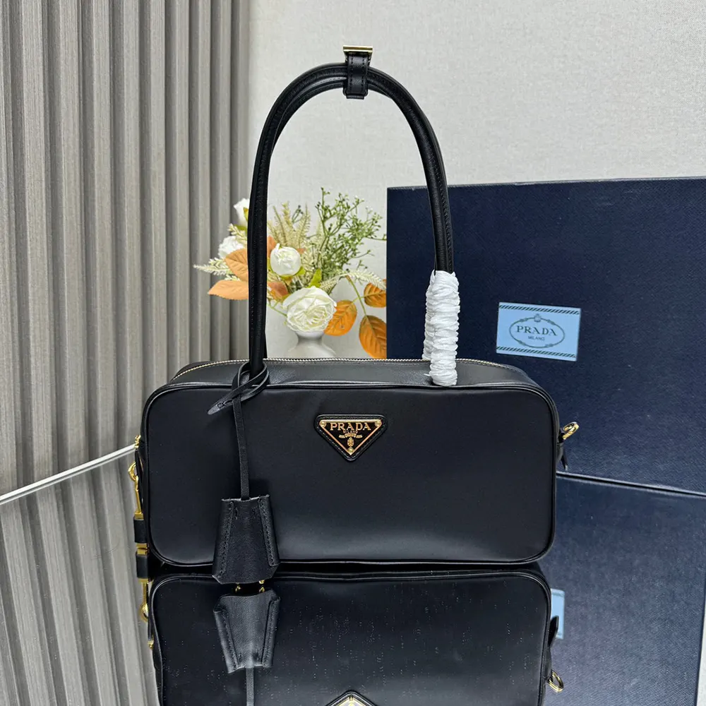 Close-up of silver-tone padlock on Prada Women Re-Nylon and Leather Small Top-handle Bag