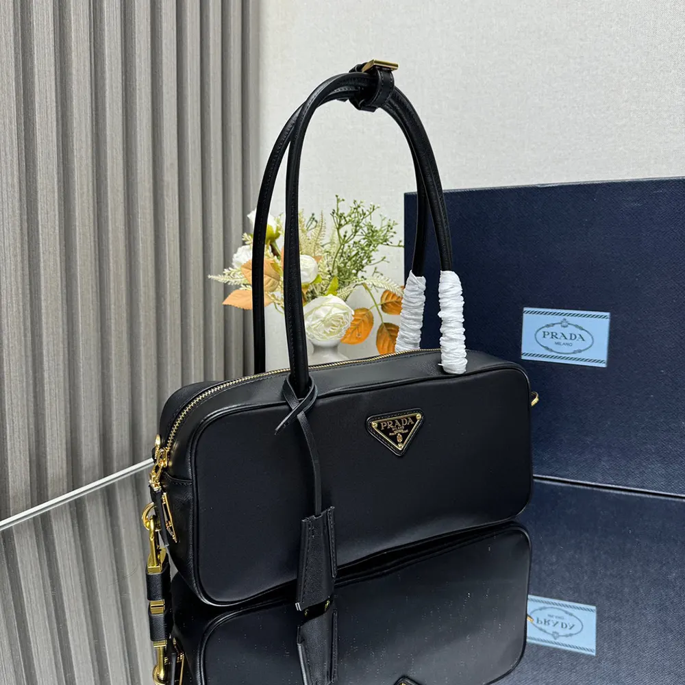 Side angle showing silhouette of Prada Women Re-Nylon and Leather Small Top-handle Bag with black leather trim