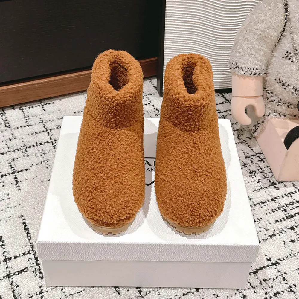 Close-up on shearling and metal hardware of Prada Women Shearling Booties-Brown