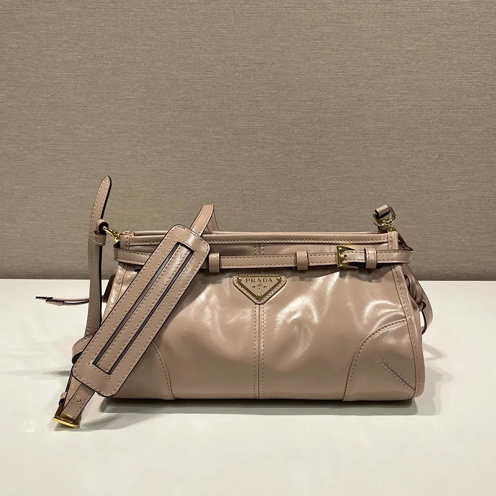 Close-up on gold triangular logo detail of Prada Women Small Leather Shoulder Bag-Pink