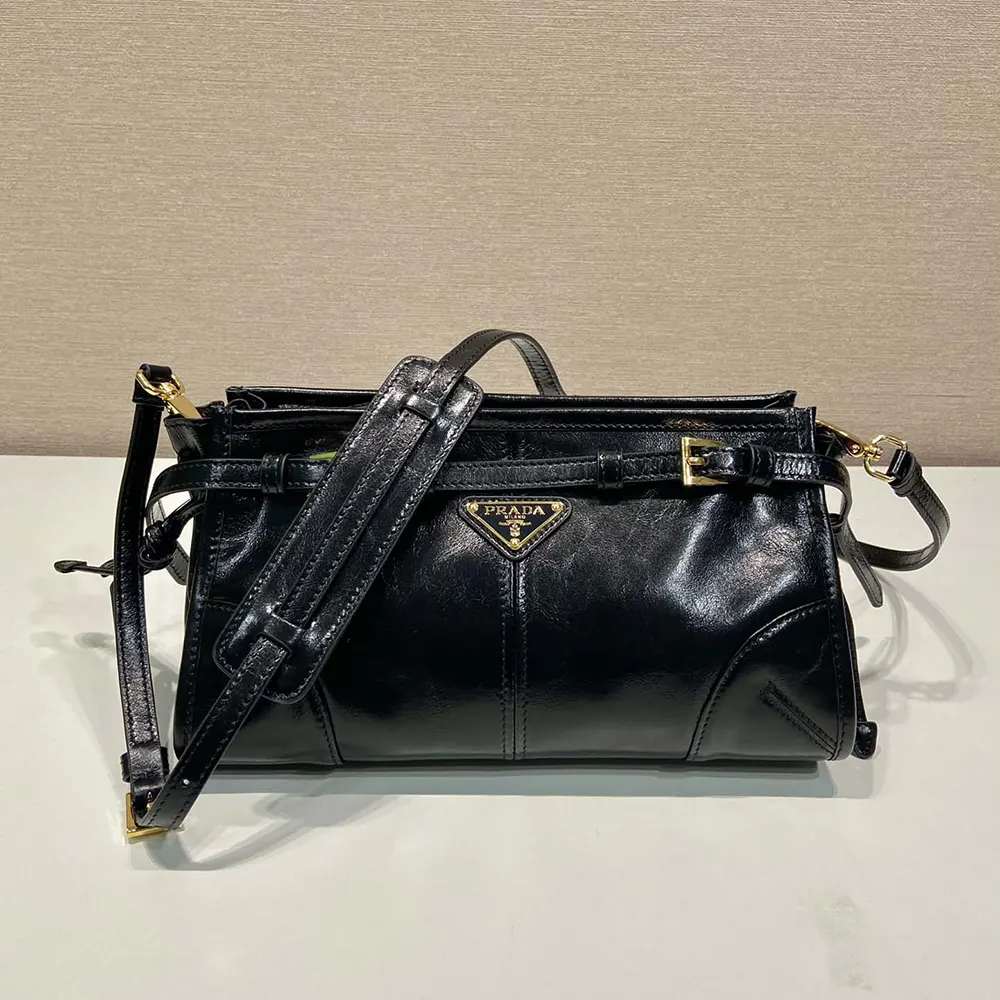 Close-up of silver-tone hardware and logo on Prada Women Small Leather Shoulder Bag-Black