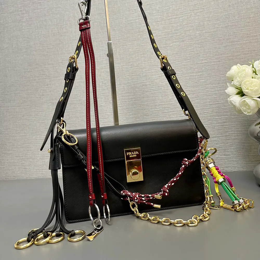 Side profile showing strap and texture of Prada Women Soft Sound Small Leather Shoulder Bag