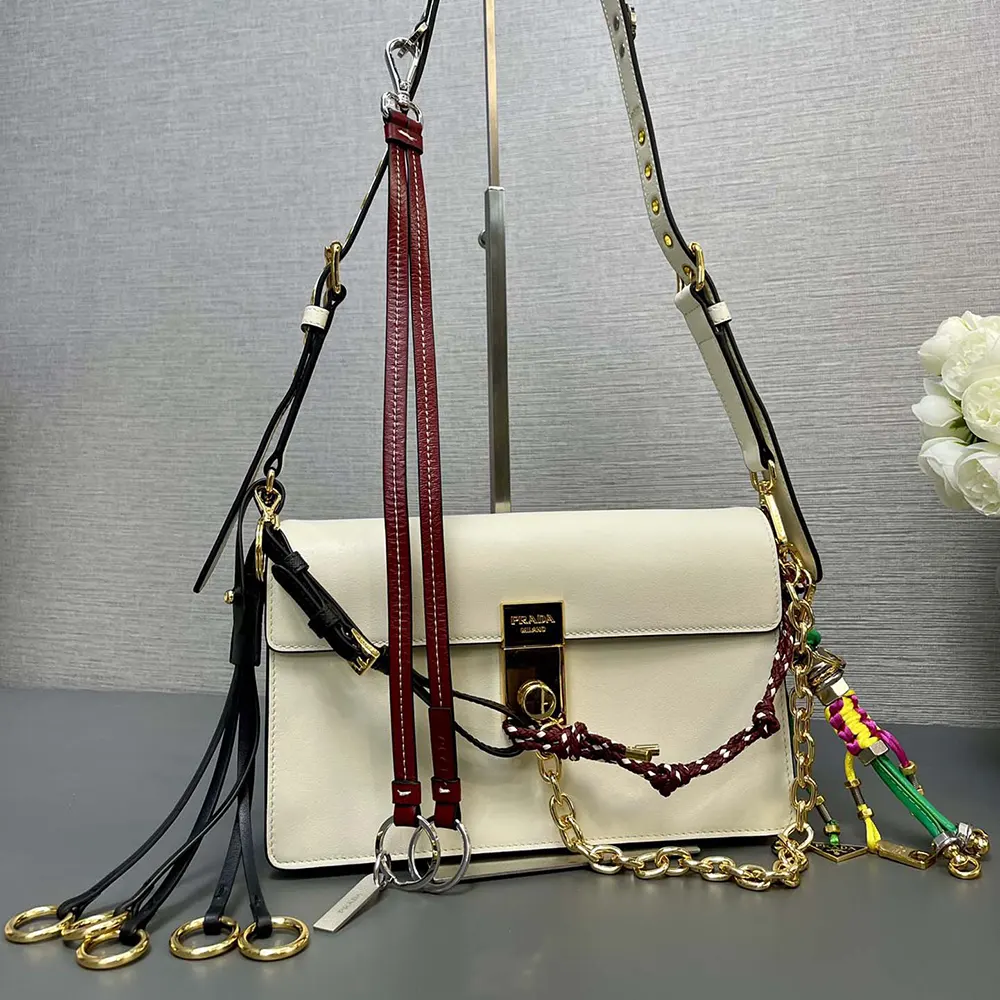 Close-up of silver-tone hardware and charms on Prada Women Soft Sound Small Leather Shoulder Bag