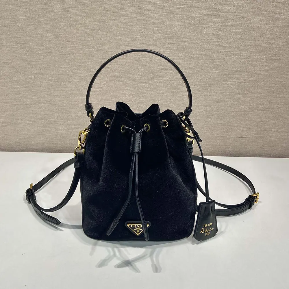 Close-up of Prada metal logo and velvet texture on mini-bag