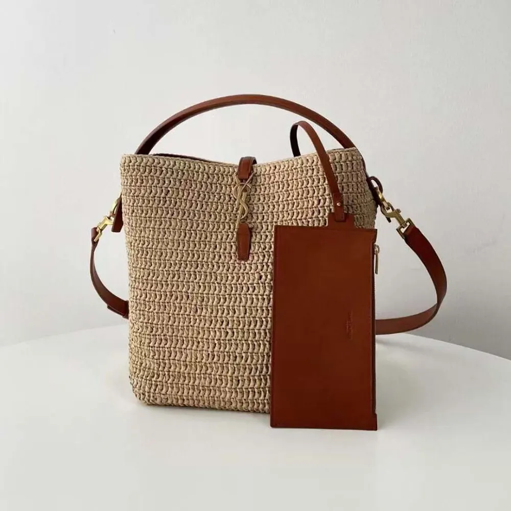 Close-up of gold YSL hardware on leather-trimmed raffia bag