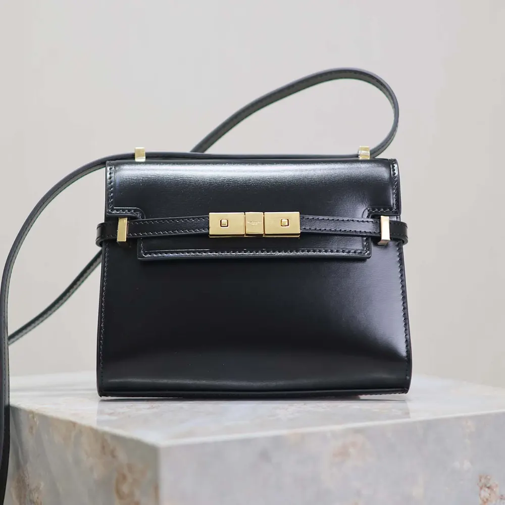 Close-up of gold YSL logo hardware on Mini Manhattan shoulder bag