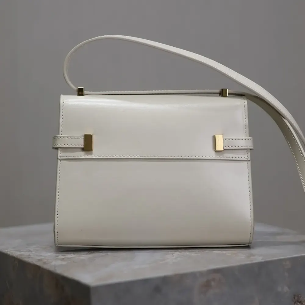 Side angle showing compact silhouette of Saint Laurent YSL Mini Manhattan bag