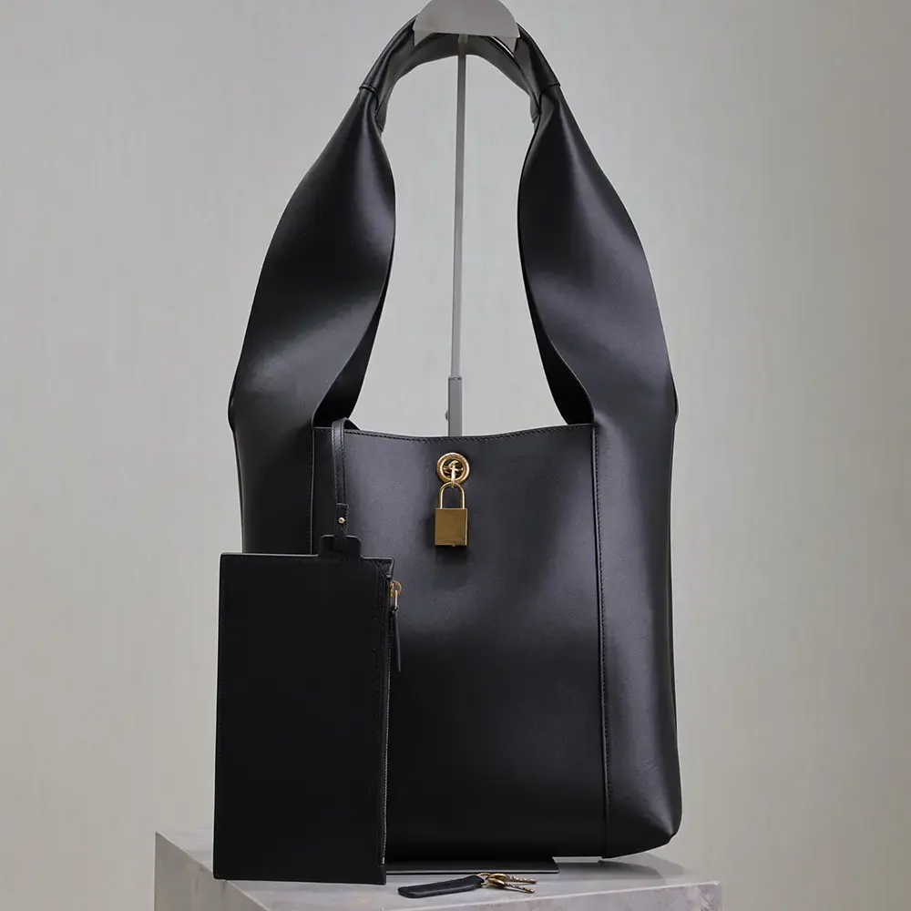 Close-up of gold YSL logo hardware on Saint Laurent YSL Women Tanger in Leather