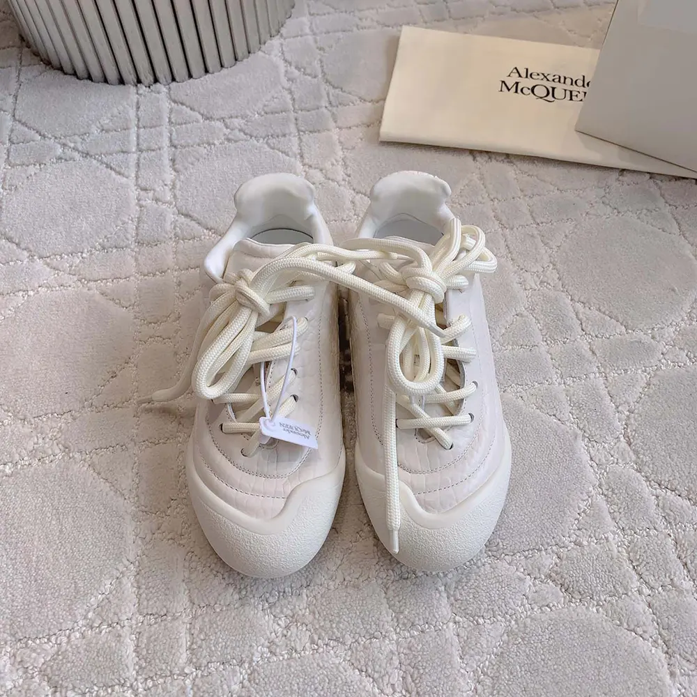 Close-up on embossed Alexander Mcqueen logo on sneaker heel
