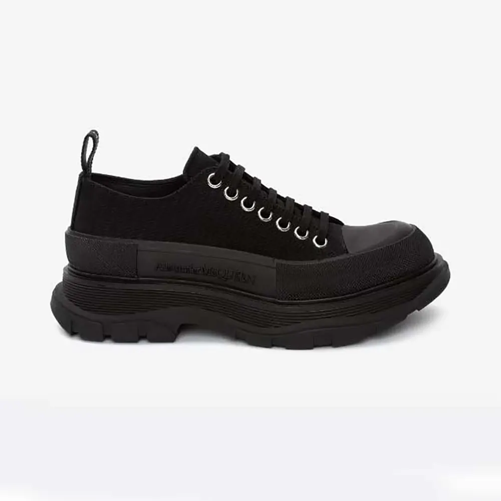 Front angle of Alexander Mcqueen Unisex Tread Slick Lace Up in Black sneakers