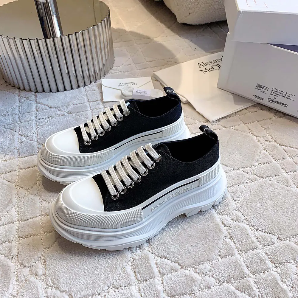 Top angle showing black and white leather panels of Alexander Mcqueen Tread Slick
