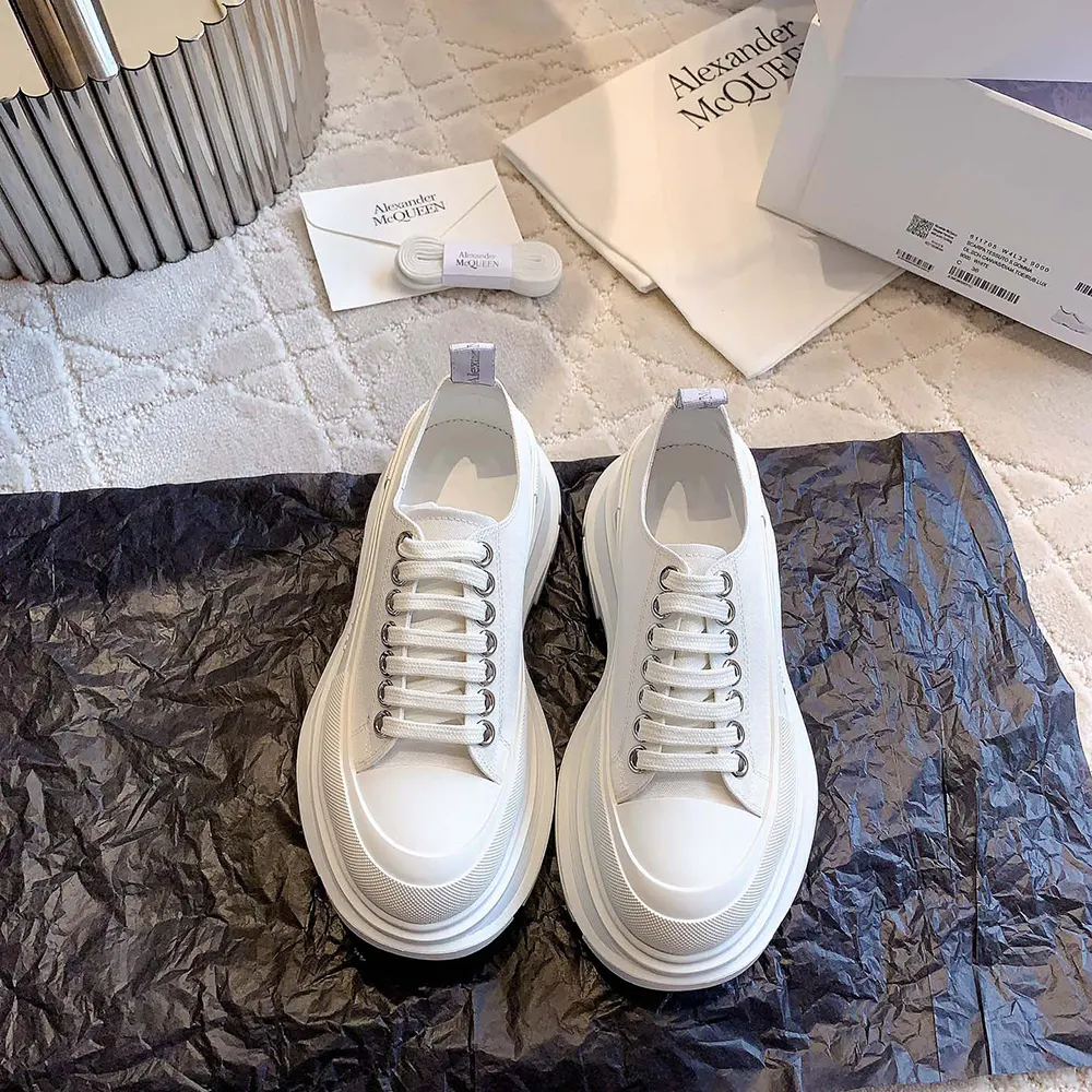 Close-up of white leather and embossed logo on Alexander Mcqueen sneaker