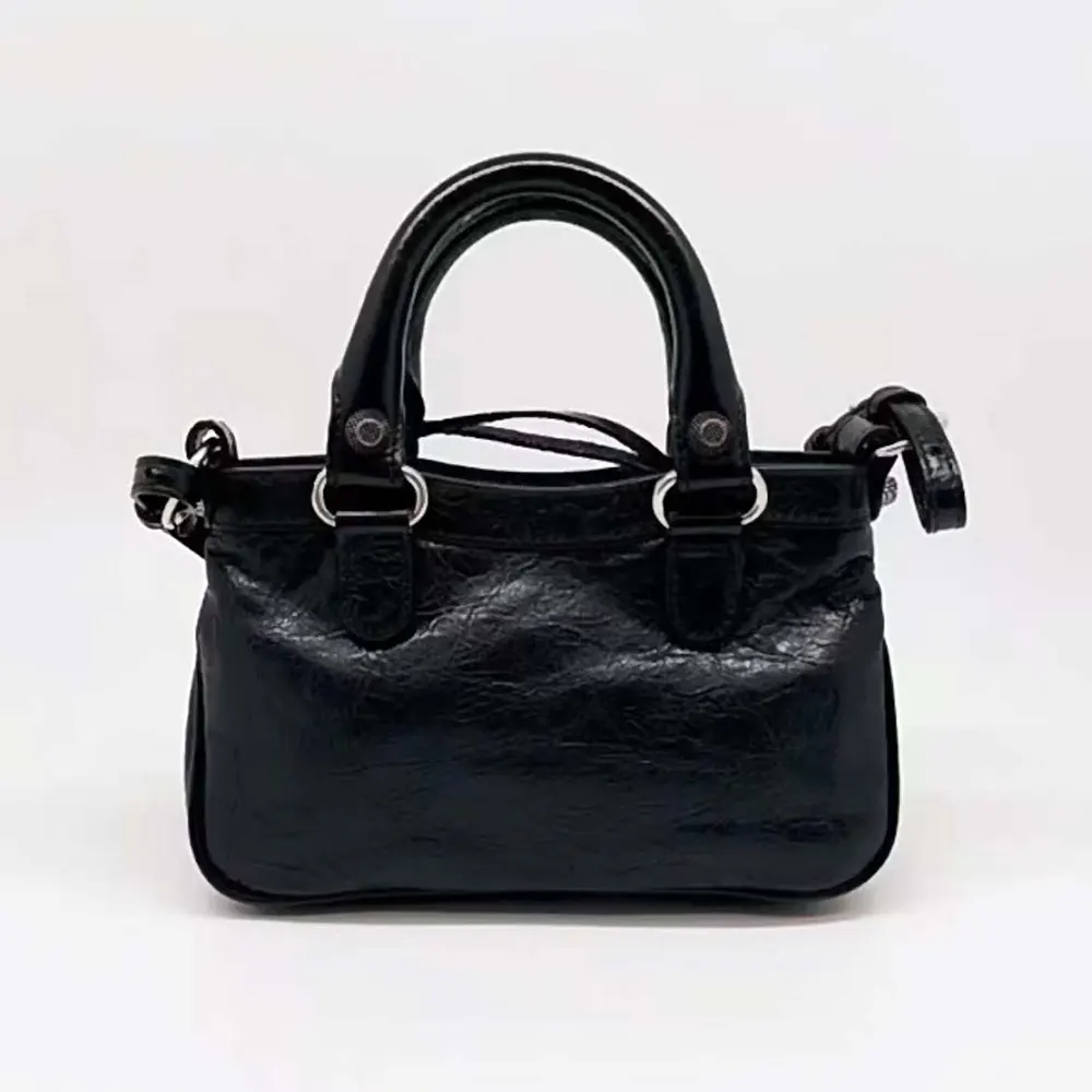 Side profile showing compact silhouette of Balenciaga Women Neo Cagole XS Handbag