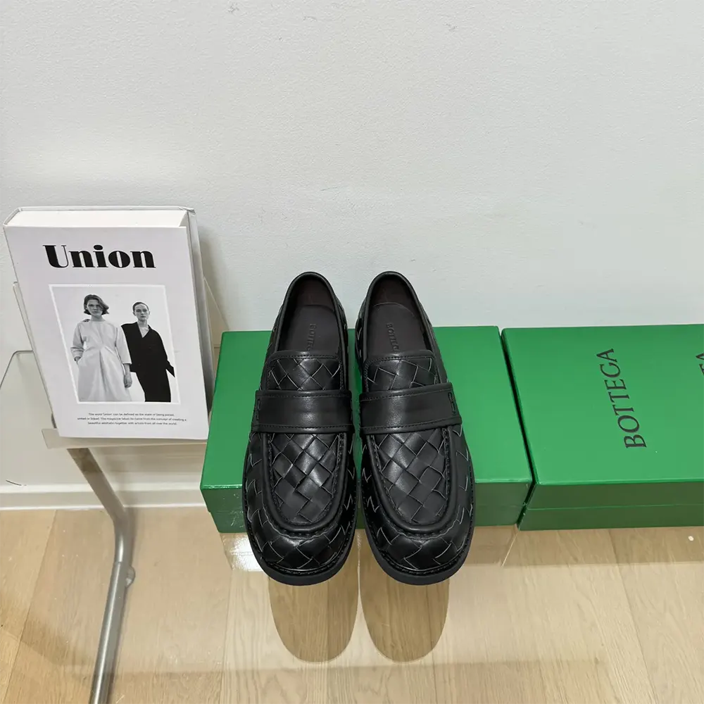 Close-up of black leather and intrecciato weave on Bottega Veneta Haddock Loafer