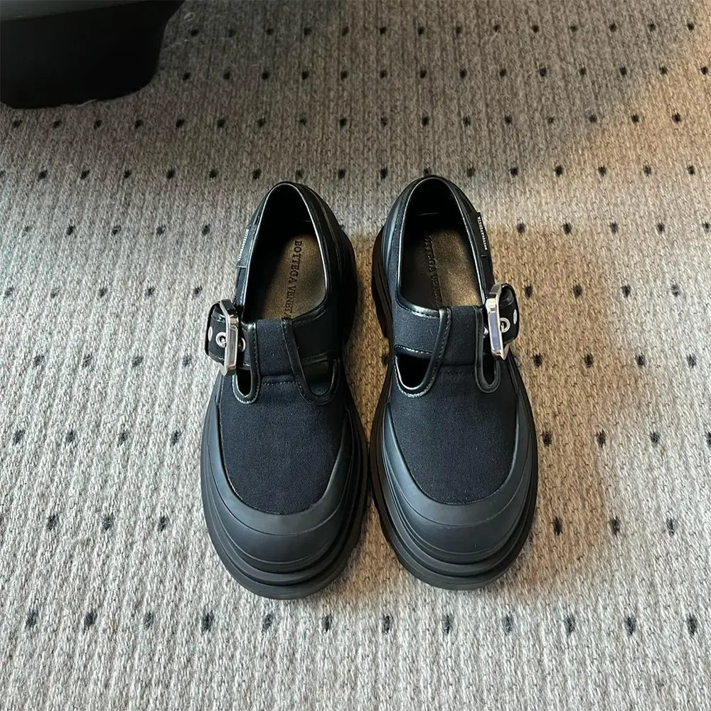 Close-up of black leather and intrecciato detail on Bottega Veneta Mary-Jane