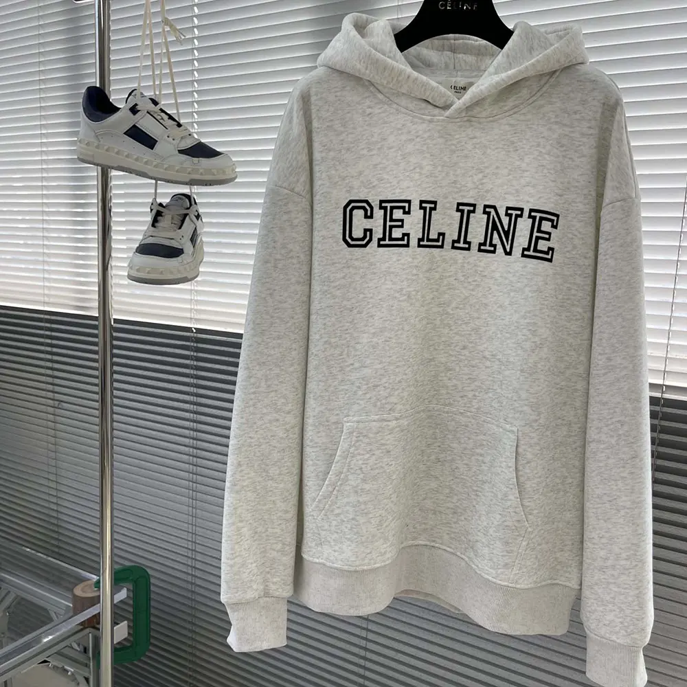 Close-up detail of Celine logo on white cotton fleece hoodie hem
