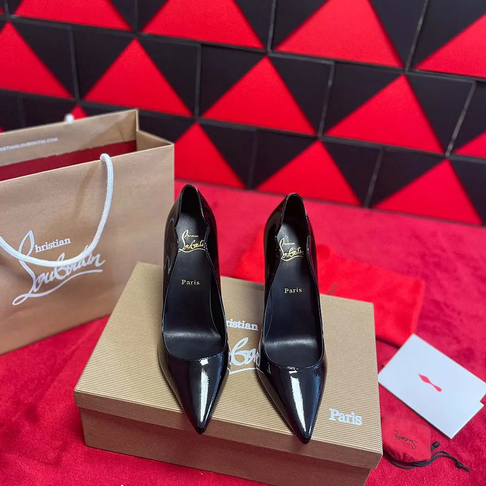 Close-up on signature red sole of Christian Louboutin Women Hot Chick patent pumps