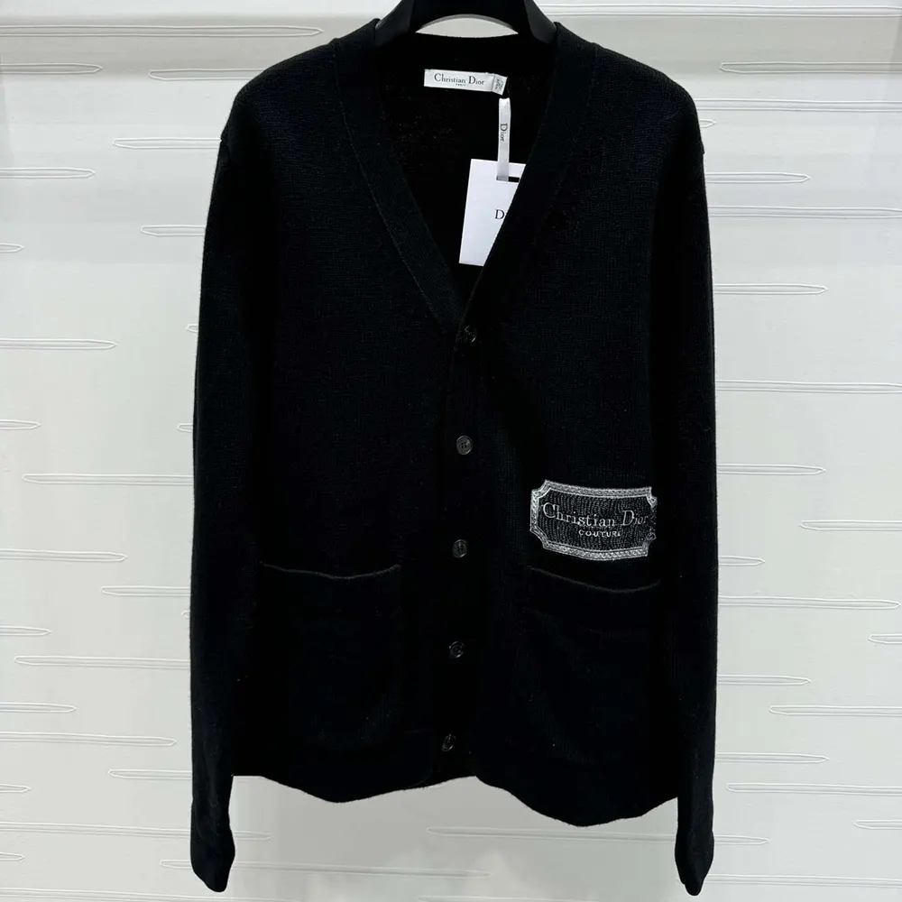 Close-up of Dior engraved buttons on black cashmere cardigan